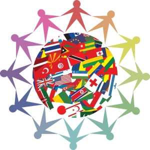 A globe brightly covered with the colorful flags of all nations and people that look like paper dolls standing in a circle around the globe holding hands. The 12 people are each a different shade of the rainbow, from red to purple.
